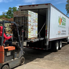 Beto lifting a pallet of fruit onto a truck