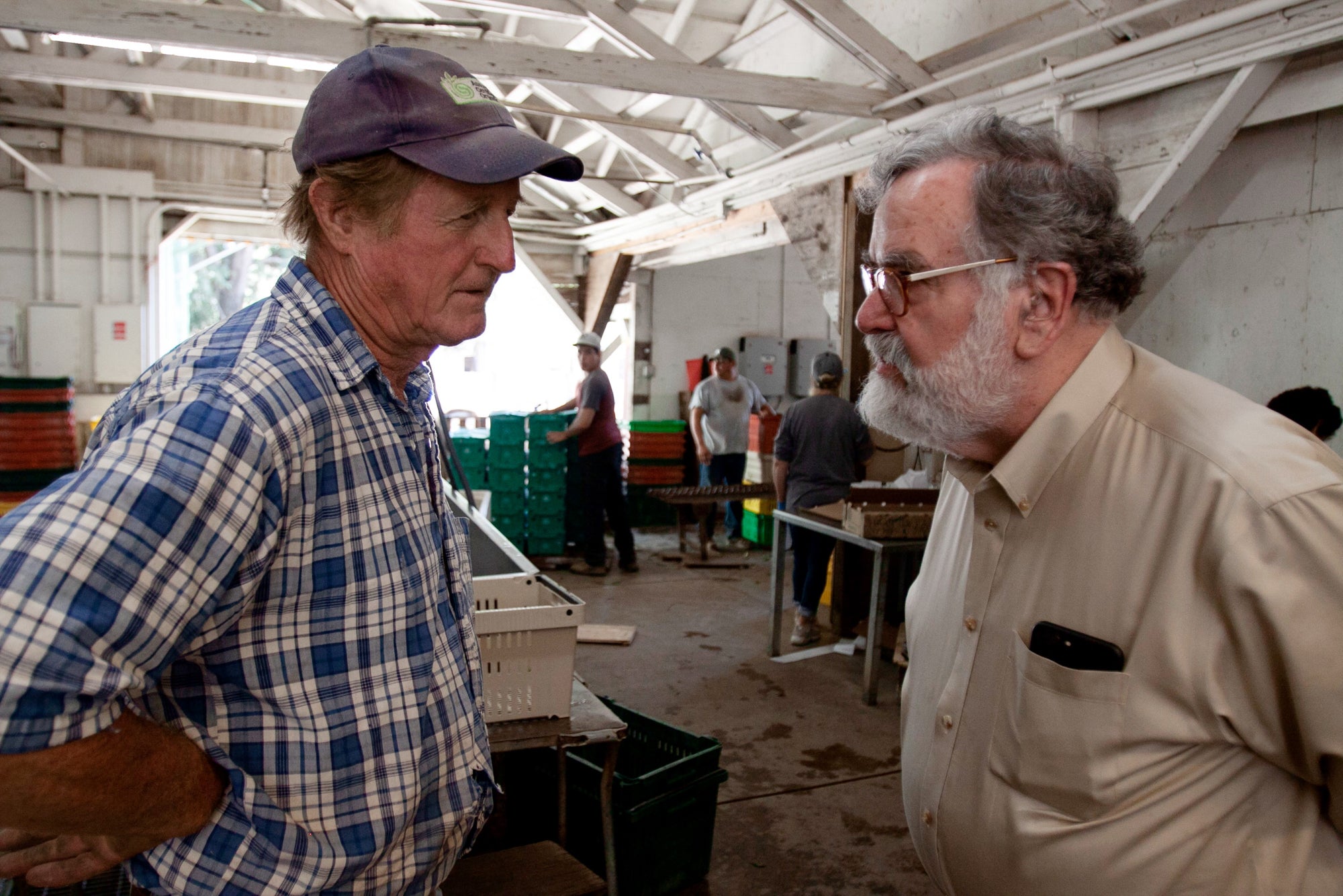 Paul Muller, left, of Full Belly Farm in the Capay Valley, talking to Bob Klein, right, of Community Grains