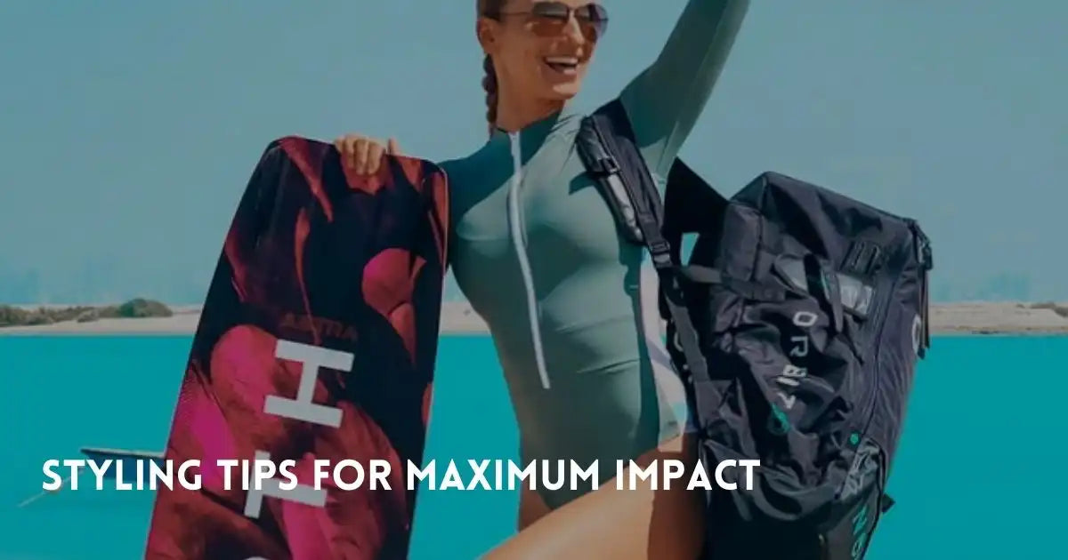 Woman in one-piece swimwear poses with a surfboard and backpack by the turquoise ocean