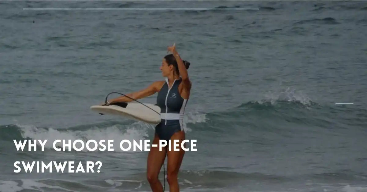 Woman in one-piece swimwear holds a surfboard in ocean waves