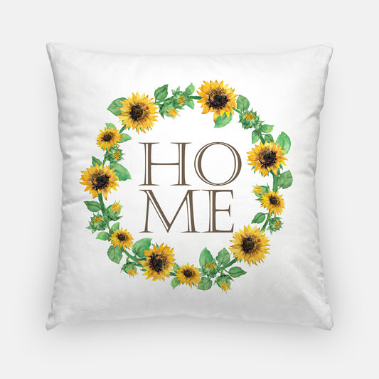 Square white pillow with a sunflower wreath with the letters HOME inside it.