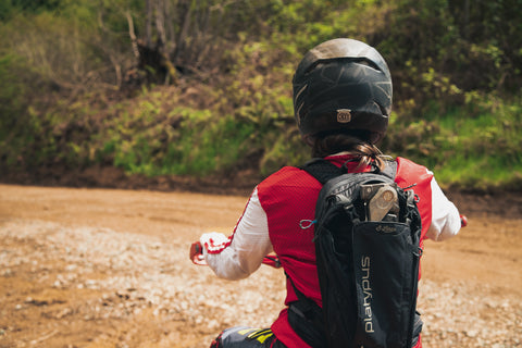 Combar attached to a backpack