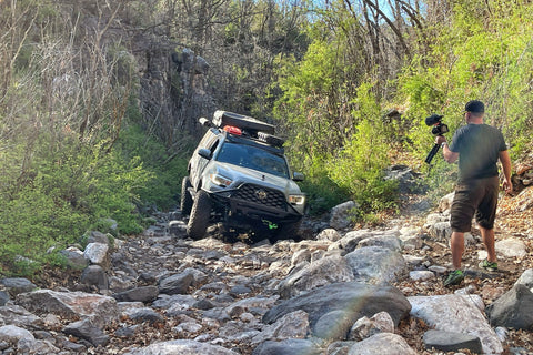 overlanding rig stuck in a dry, socky creek bed
