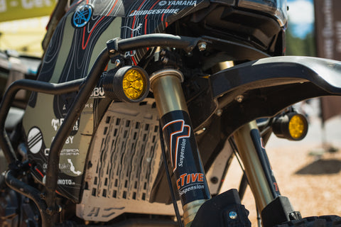 A close-up of the front suspension of an ADV motorcycle