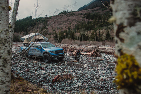 overlanding truck parked near river