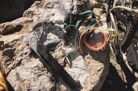 COMBAR on a rock with straps around it