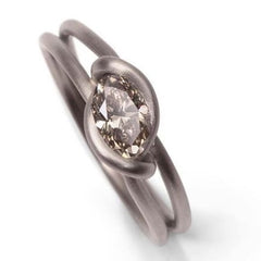 Leen Heyne - The Knotted Ring made from a single 750 grey gold flat-rolled wire with a brown oval diamond.