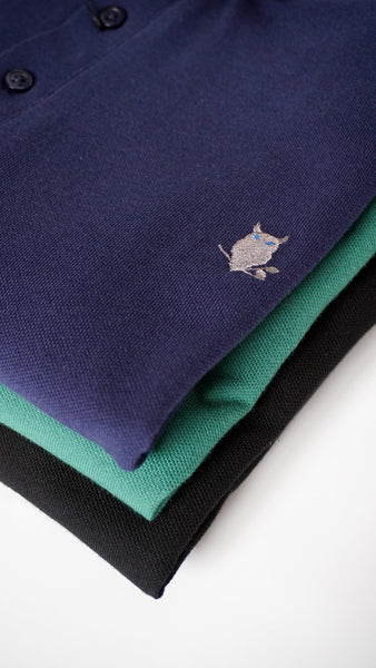 Stack of three polo shirts with suave owl logo visible. 