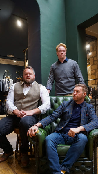 Collection of smart casual men's autumn outfits worn by three models.