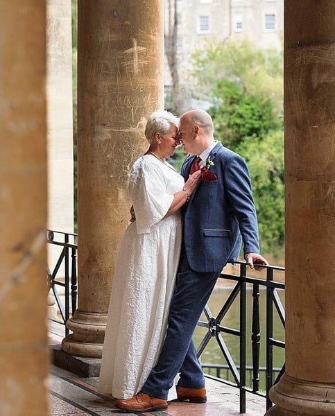 Couple stand in passionate embrace on Bath Weir.