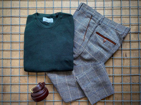 Blend jumper with Ted trousers and belt on top of wooden background.