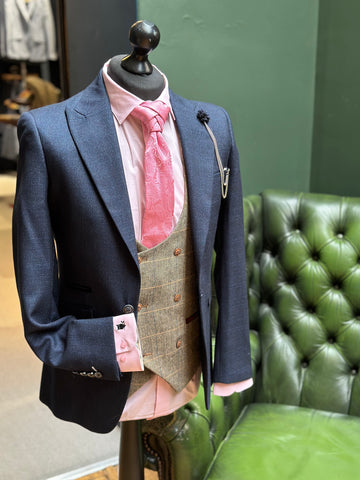 Navy suit for men, Caridi, styled with pink accessories and a brown waistcoat.