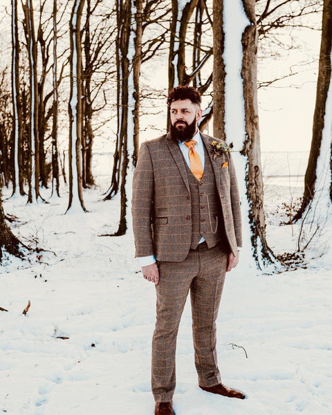 Model wears a Ted suit with yellow accessories preparing for a Christmas wedding.