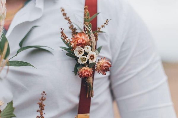 Close up on boutonniere on groom.