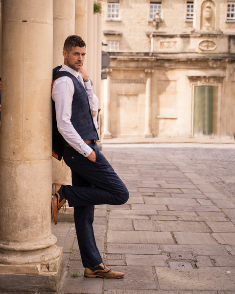 Model wearing Cody suit leans against column near Bath Thermae Spa