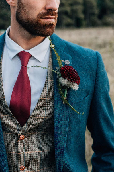 Model wearing mix and matched men's jacket and men's waistcoat.