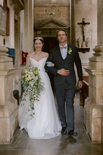 Groom wearing Jenson walks bride down aisle.