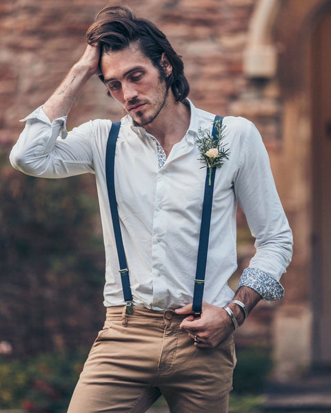 Groom wearing SUAVE OWL white shirt with boutonniere pinned into braces.