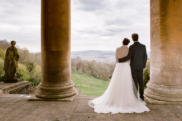 Prior Park College with view of rolling hills and city of Bath - bride and groom in wedding attire