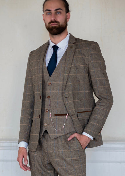 Brown suit for men, the Ted, shown on a model wearing a white SUAVE OWL shirt and navy accessories.