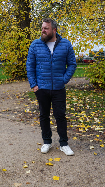 Co-founder Tony wearing a true blue puffa jacket for men.
