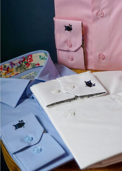 SUAVE OWL formal shirts displayed together on table.