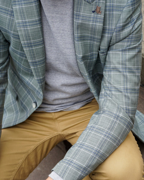 Smart casual men's outfit with knitwear, suit jacket, and chinos.