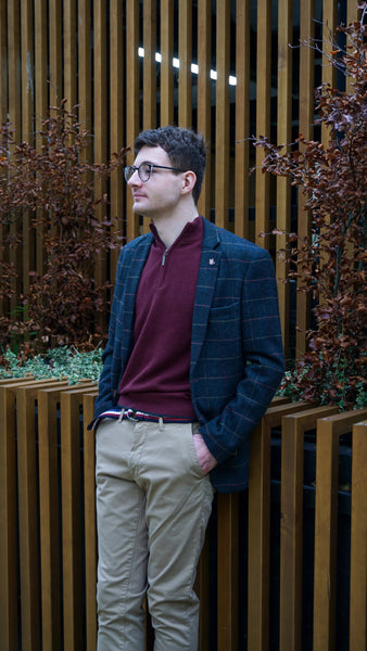 Men's smart casual outfit with chinos, jumper, and formal suit jacket.