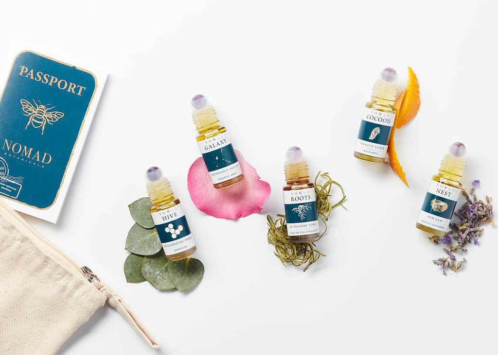 Nomad Botanicals Carry-on Wellness Collection of 5 essential oil blends with botanicals and a bag