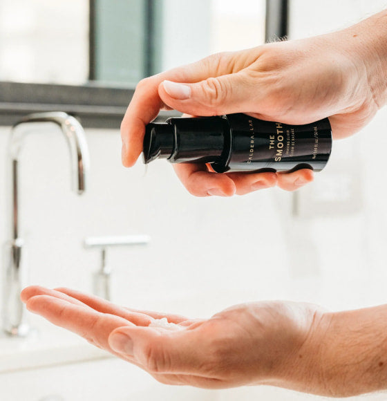 The Smooth shaving elixir by Caldera Lab being dispensed into the palm of a hand.