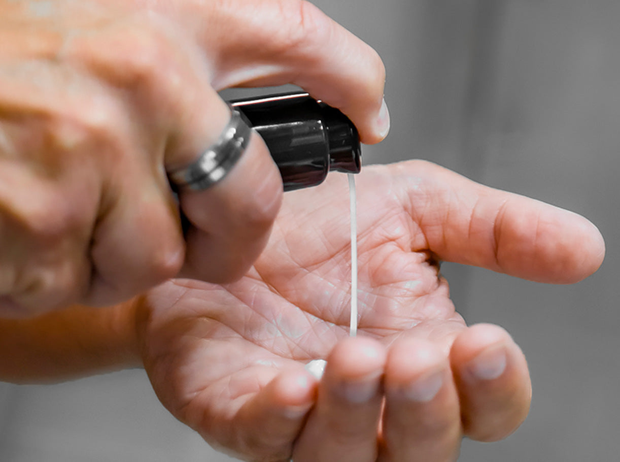 The Smooth shaving elixir by Caldera Lab being dispensed into the palm of an open hand