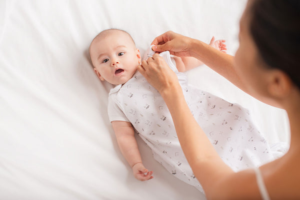 mother preparing her baby for bedtime with KeaBabies Sleep Sack