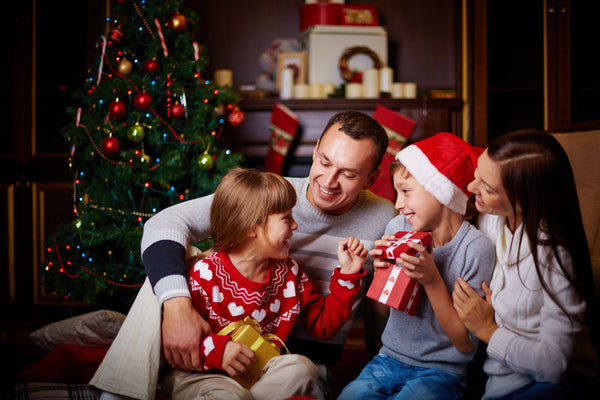 Family with gifts on Christmas evening