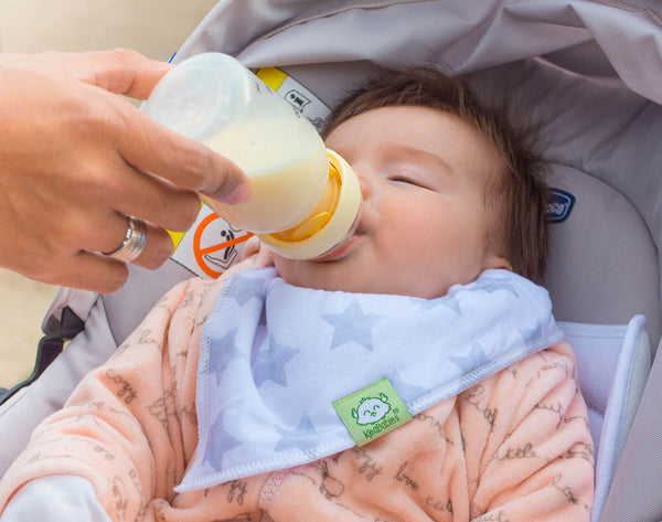 Mother is feeding her baby with a baby bottle