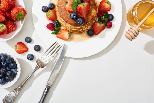 Top View Delicious Pancakes Honey Blueberries Strawberries Plate Cutlery Marble