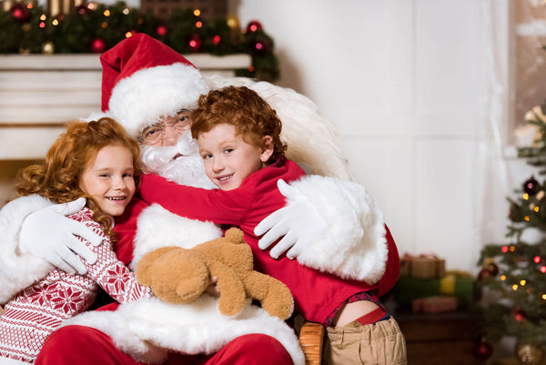 Santa Claus with children holding gift boxes
