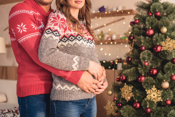 Husband Hugging Pregnant Wife Christmas Tree Home