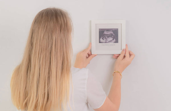woman holding a picture of sonogram in KeaBabies frame