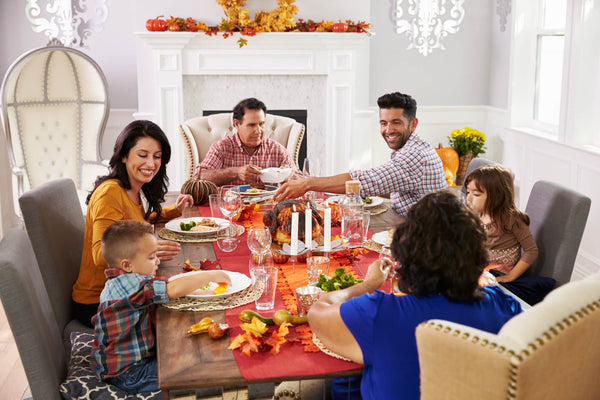 Family Enjoying Thanksgiving Meal At Table