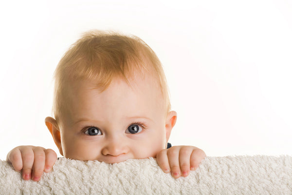 curious baby peeping out of crib