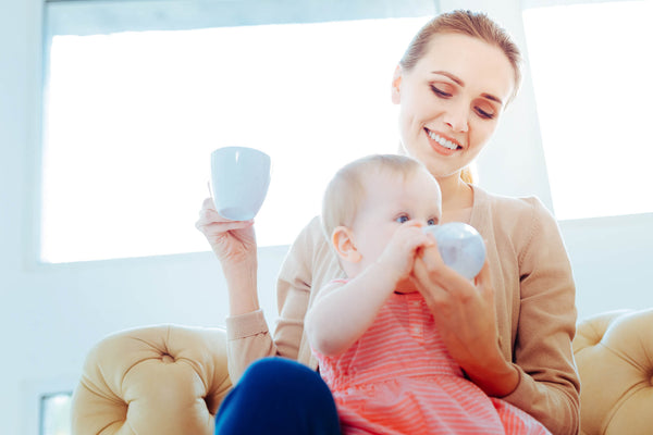 Mother Feeding Her Little Child Bottle