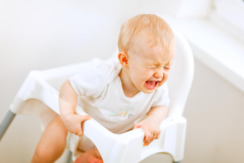 Crying baby in baby chair