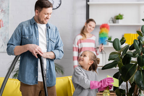 Girl Cleaning Plant Looking Father Vacuum Cleaner Home