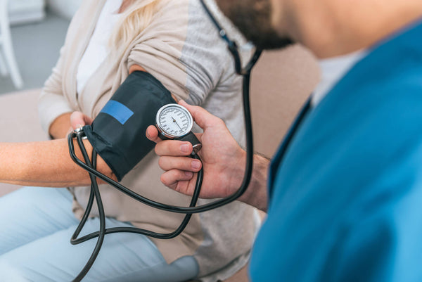 Close Partial View Caregiver Measuring Blood Pressure