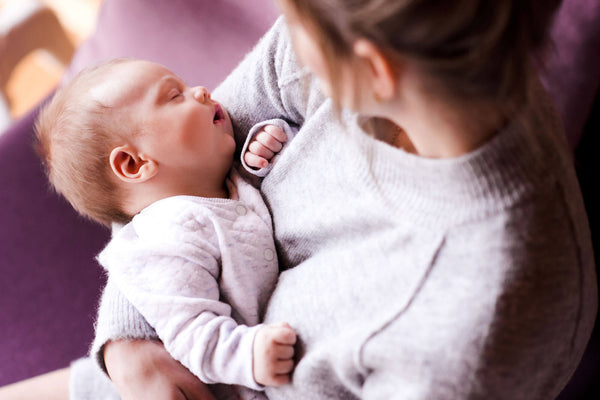 mother holding a sleeping baby