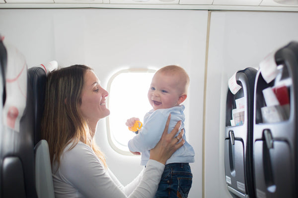 young mom and toddler boy in an airplane