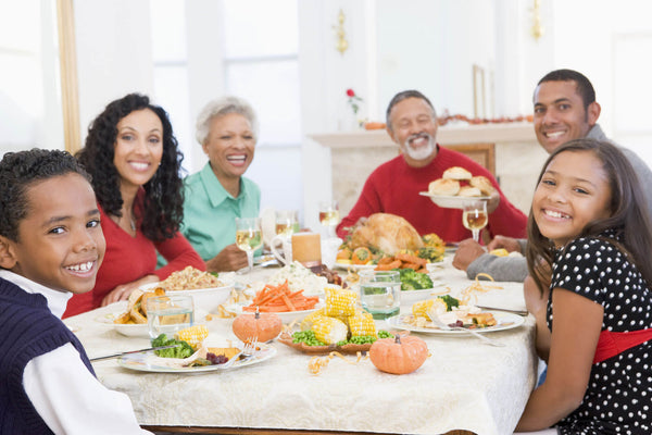 Family Enjoying Thanksgiving Meal At Table