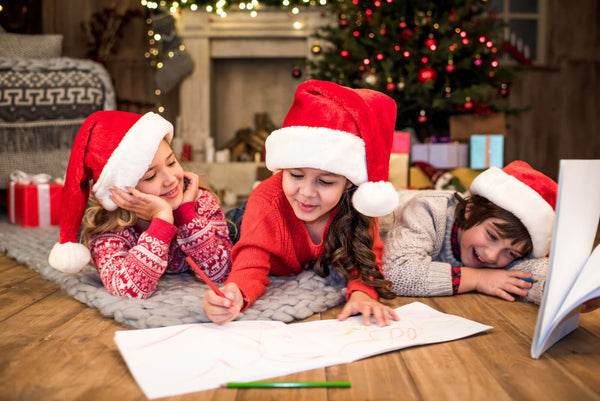 Happy kids drawing picture writing a letter to Santa