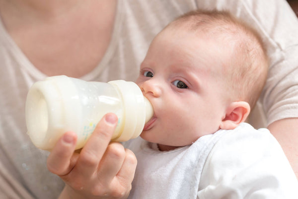 Mother Feeding Baby Milk Bottle