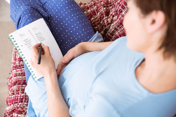 Pregnant woman listing baby name options
